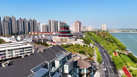 aerial view of a city with a traditional chinese tower and river