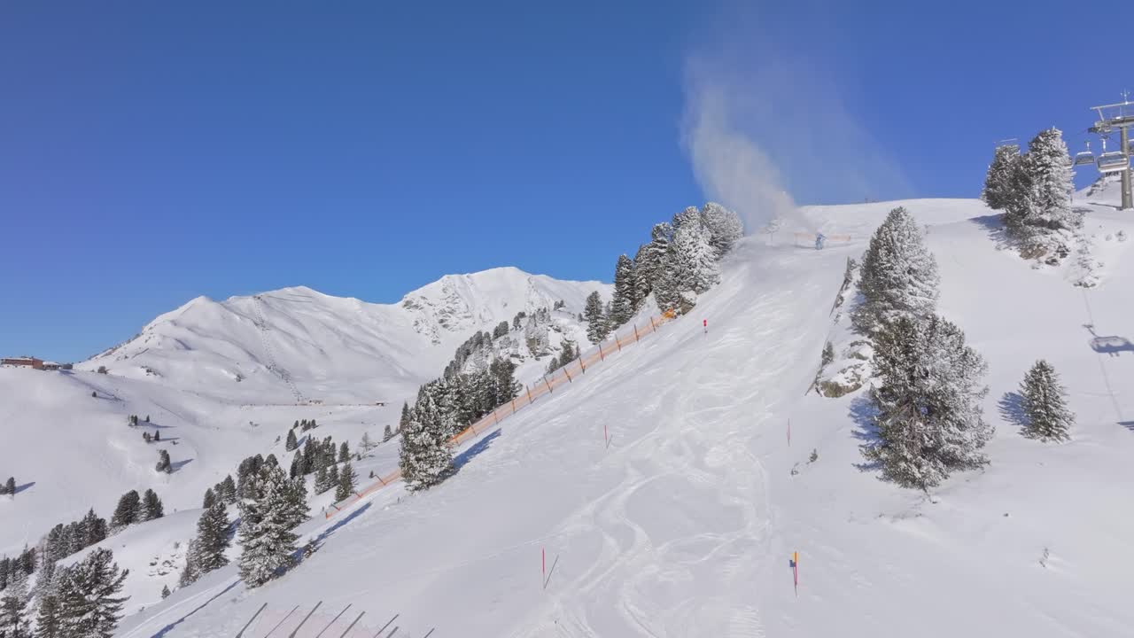 Sunlit, busy downhill run with chairlift traffic in Obertauern, Austria