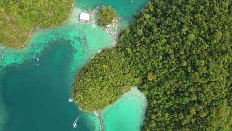 top down aerial view of tropical sugba lagoon, turquoise sea and green coastline at siargao island, philippines