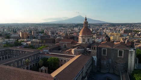 historic catania with san nicolò l'arena church and mount etna in the distance