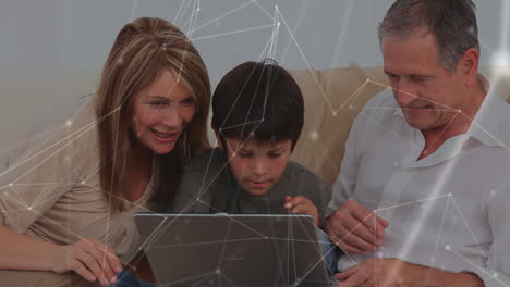 animation of caucasian man and woman and their son playing together at home using a laptop