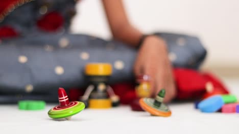 closeup of child hands playing with colorful wooden toy at home in india