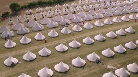 drone aerial wide shot of bell tents at campsite