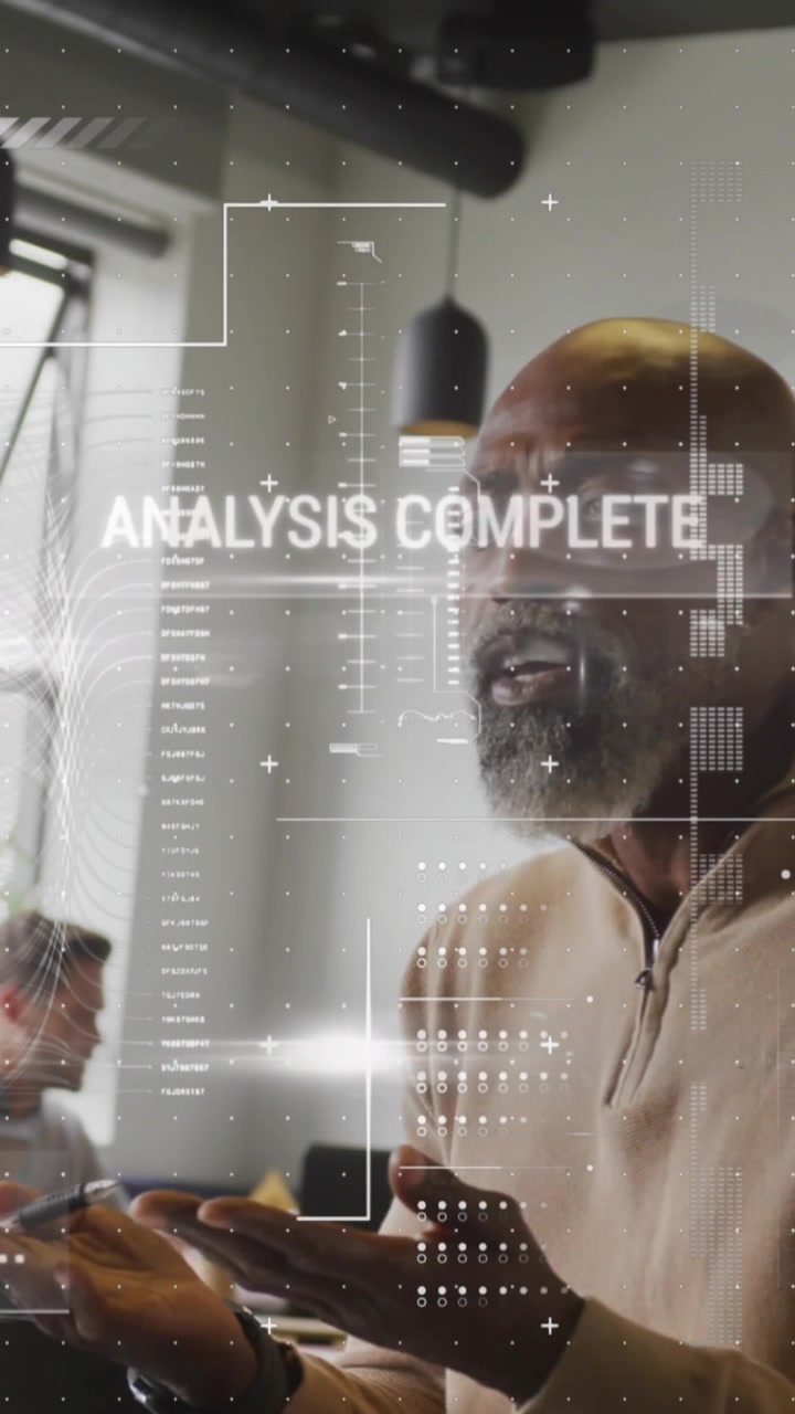 Animation of graphs, texts, computer language over african american man working on laptop in office