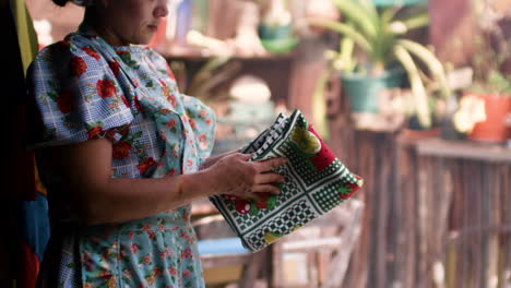 waitress unfolding tablecloth