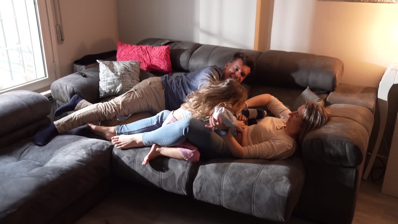 Family bonding and playing on the couch at home