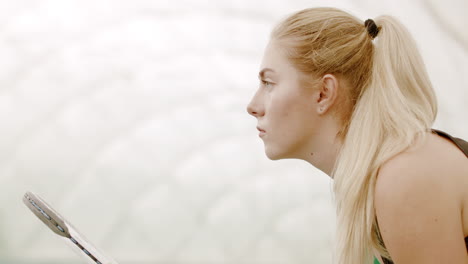 CU-Portrait-of-focused-young-Caucasian-female-tennis-player-preparing-for-a-serve.-120-FPS-slow-motion,-4K-UHD-RAW-graded-footage