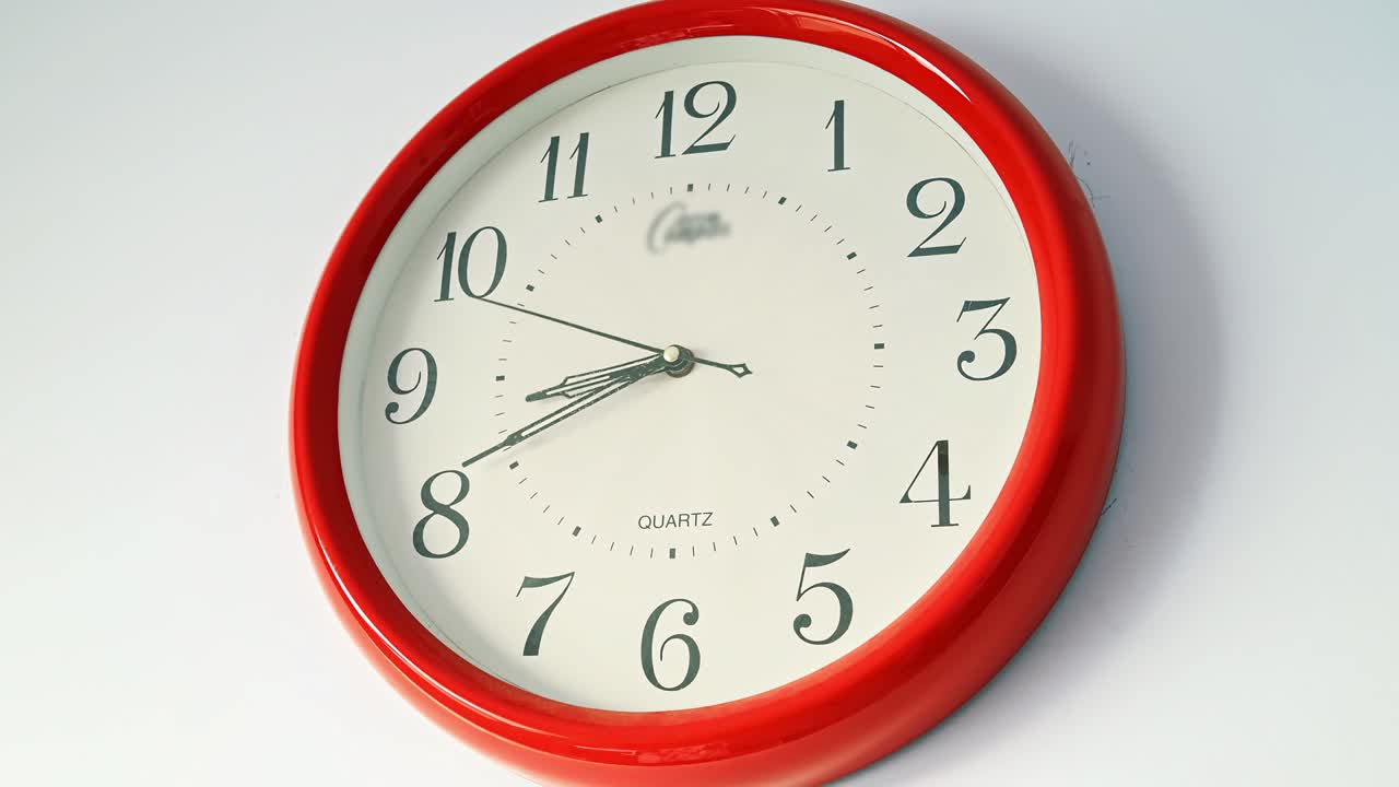Close-up of wall clock with running time pointer in white background. Time-lapse