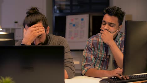 creative team with computer working late at office