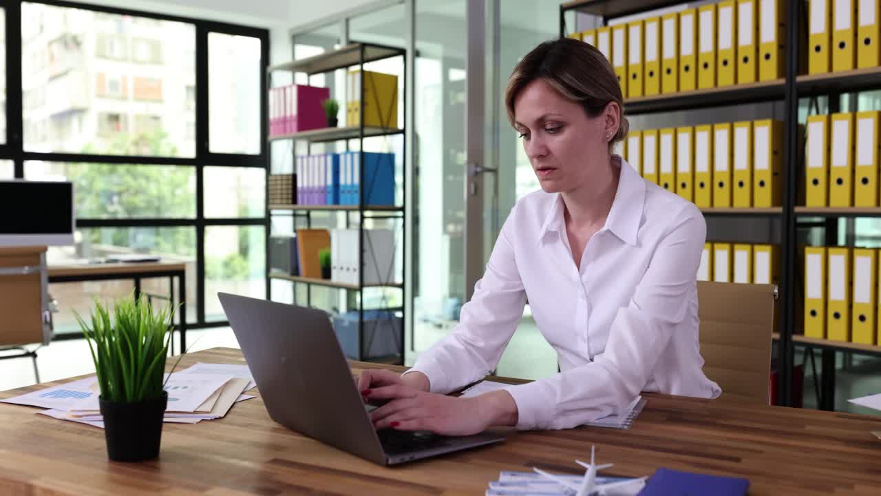 mujer trabajando en una computadora portátil en la oficina