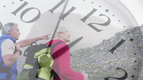 Happy-caucasian-senior-couple-hiking-in-mountains-over-spinning-clock