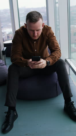 young man using mobile phone. work stress concept of man vertical video