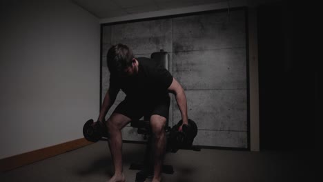 Seated-front-deltoid-raises,-cinematic-lighting,-white-man-dressed-in-black-gym-attire