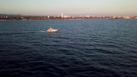 Boat-In-Santa-Monica-Bay-during-beautiful-sunset-Aerial-Drone