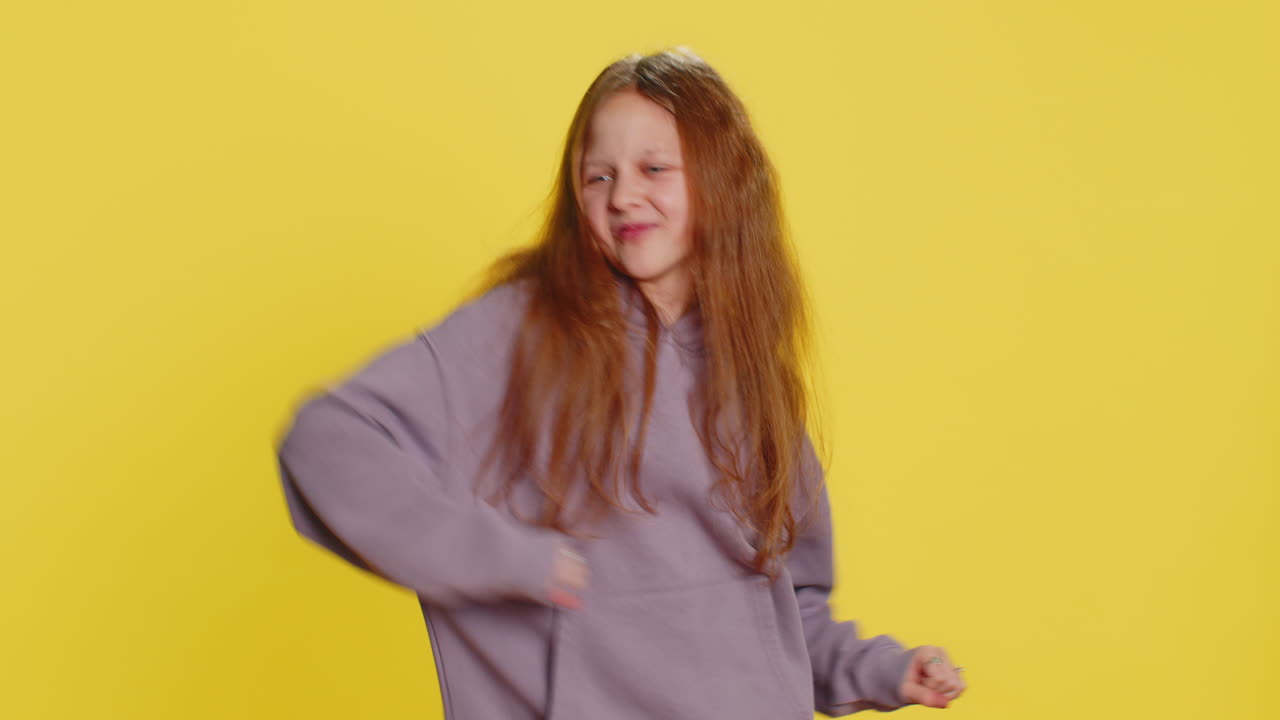 Happy child girl kid listening music dancing disco having fun relaxing on party making funny moves