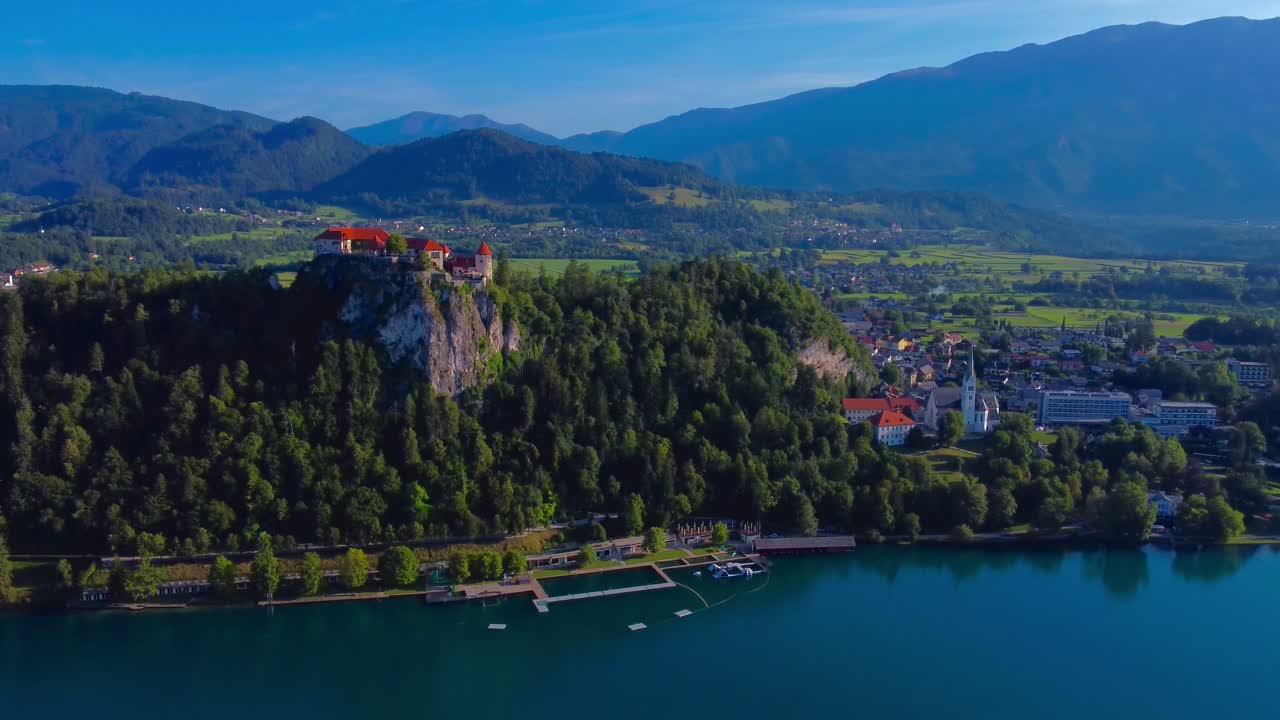 Aerial drone footage in 4K of Bled Castle and bled town on a beautiful summer's morning - Lake Bled, Slovenia