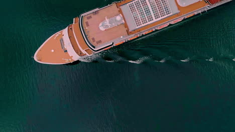 Straight-down-aerial-view-of-a-cruise-ship-or-ferry-on-a-fjord-in-Sweden