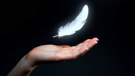 glowing white feather floating above an open hand
