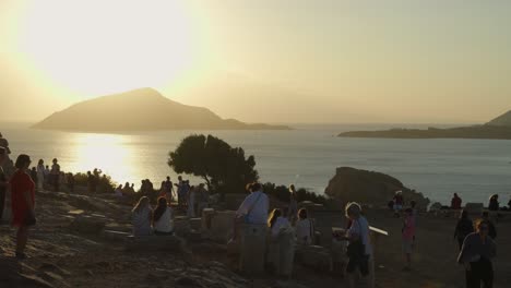 crowds of people watching sunset from top of hill