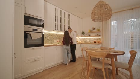 loving couple making a sandwich in kitchen-living room