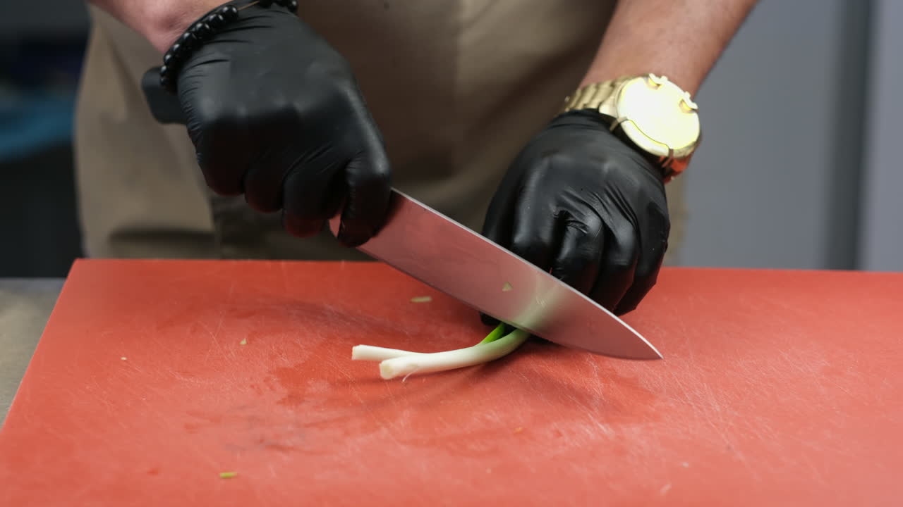 Chef expertly chopping vegetables with a sharp knife