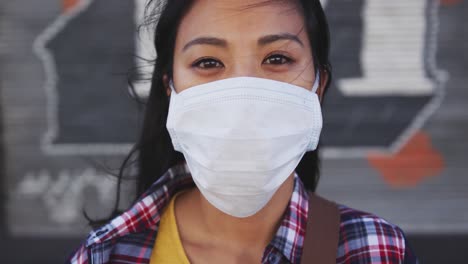 Woman-wearing-medical-coronavirus-mask-looking-at-camera