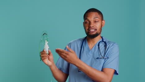 nurse holding handheld nebulizer used for delivering aerosols