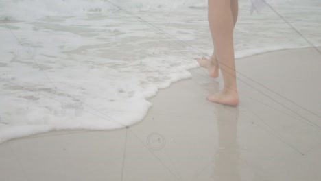 animation of network of connections over woman walking on beach