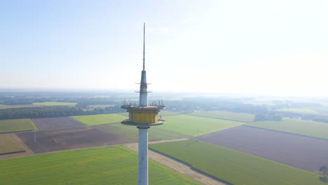 broadcast tower plettenberg on countryside fields during foggy morning in dotternhausen, germany