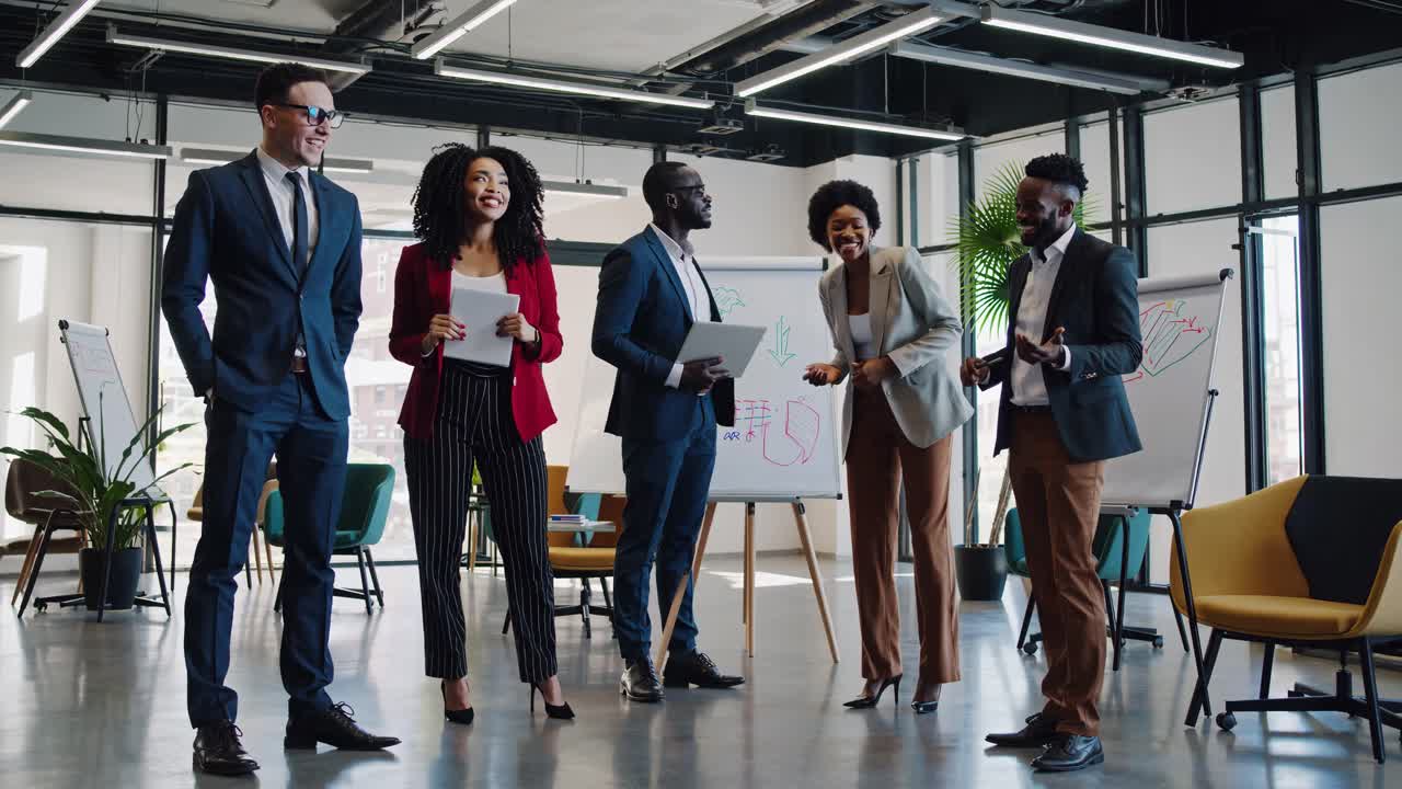 A group of professionals in a modern office, engaged in discussion