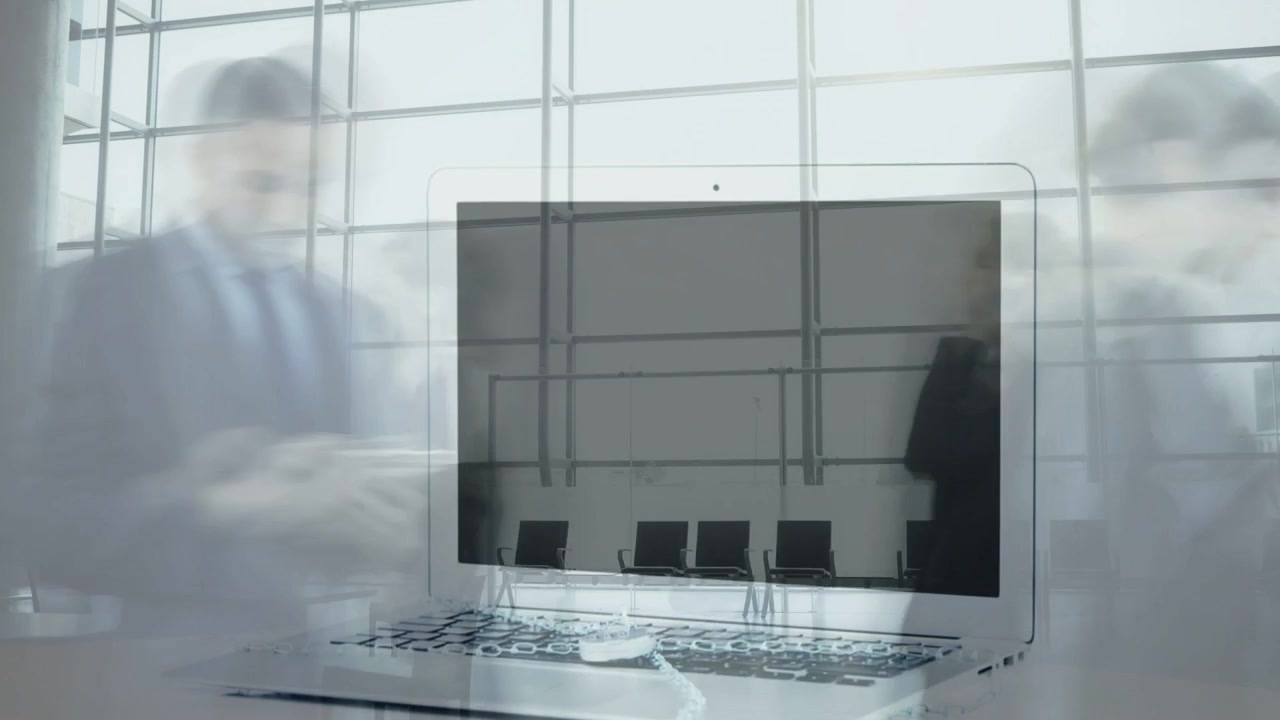Commuters passing glass atrium, laptop outline appearing, growing into foreground technology demo