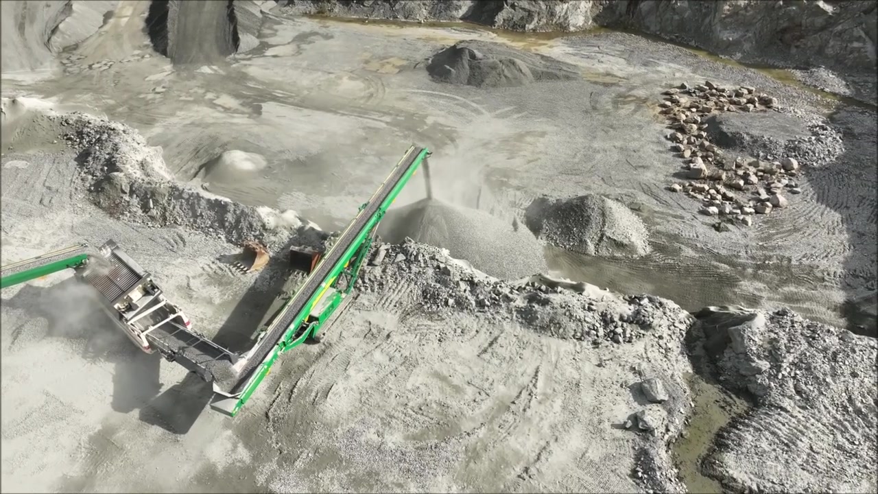 Drone captures busy stone quarry at work with machinery from northern ireland