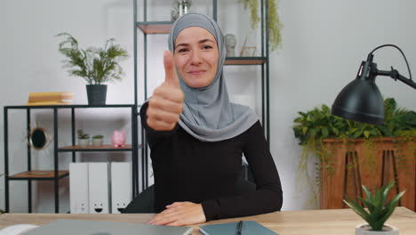 happy muslim business woman showing thumbs up, like sign positive something good, positive feedback