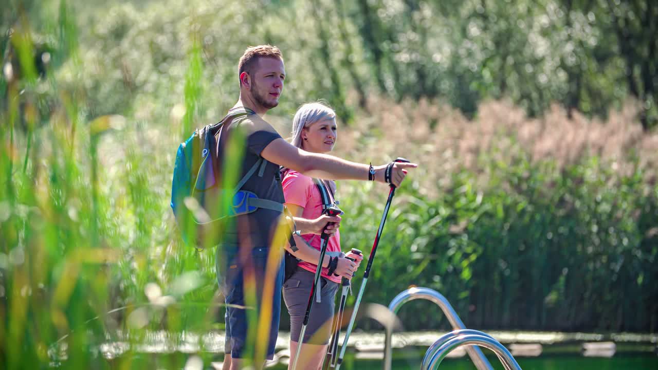Two people overlooking and pointing out places of interest in nature. Green window, Slovenia
