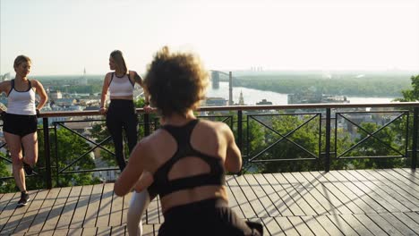 women's outdoor workout session with a city view