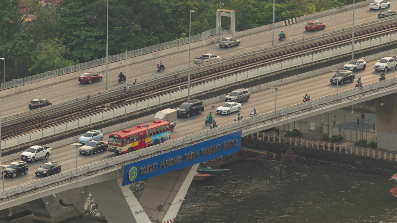 rush hour traffic over river bridge in bangkok