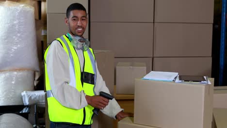 warehouse worker scanning barcodes on boxes