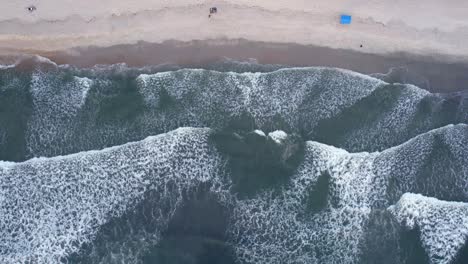 aerial view of waves at the barra do sahy beach, in brazil - cenital, drone shot