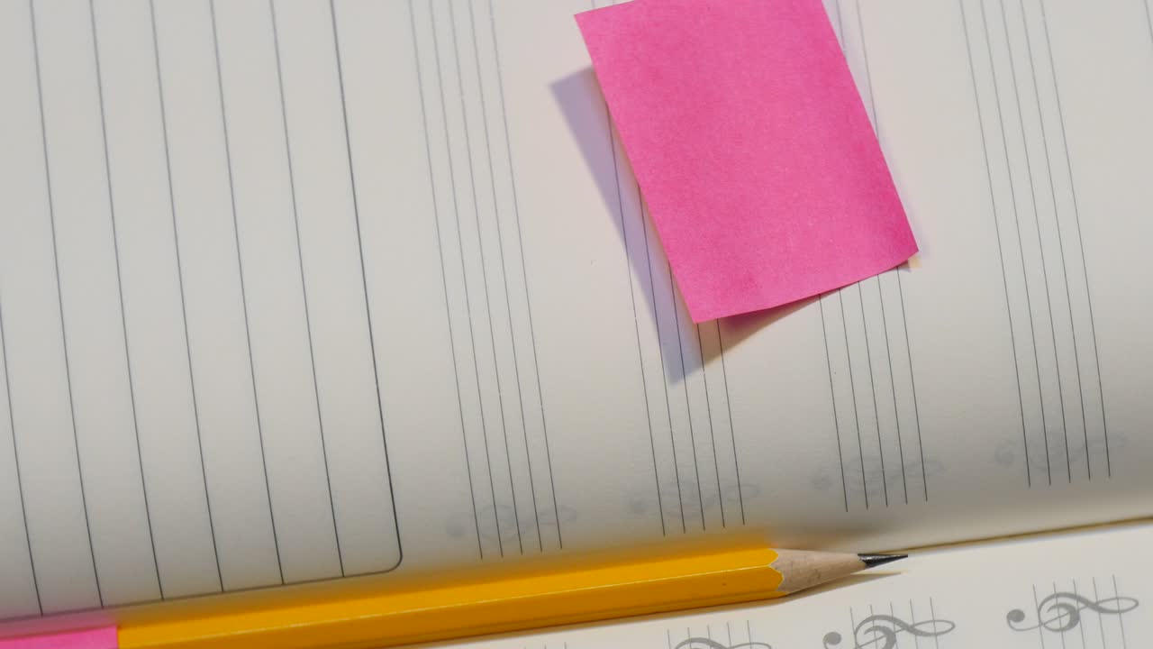 Pencil on music note book in rotation