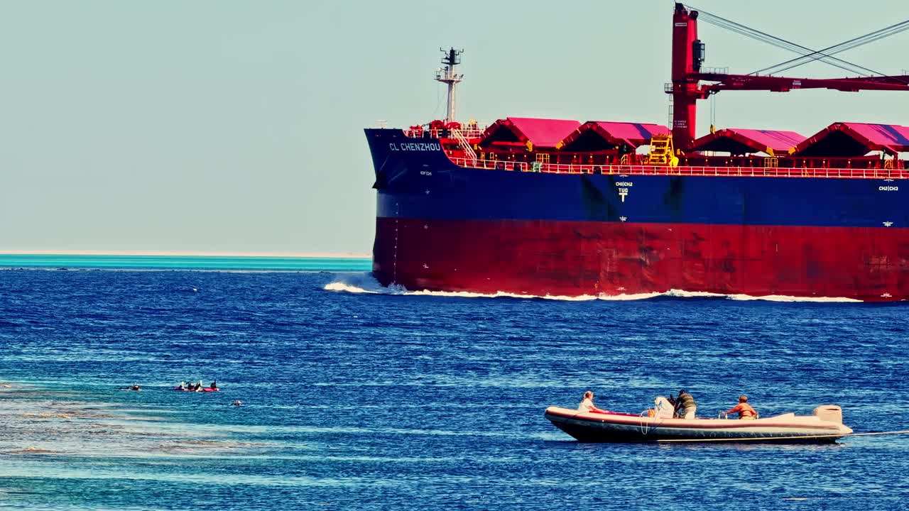 Cargo ship and boat on the vibrant Red Sea in Sharm El Sheikh, Egypt