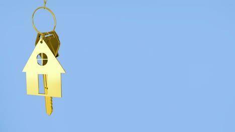 Animation-of-golden-house-keys-against-copy-space-on-blue-background