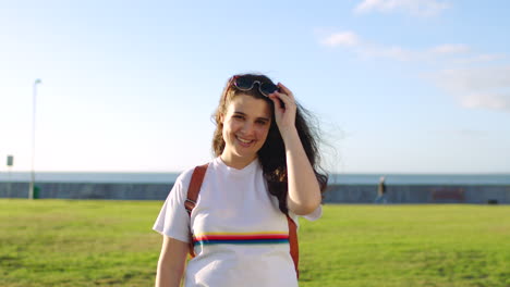 Portrait-of-girl-on-holiday-smiling-as-she-removes