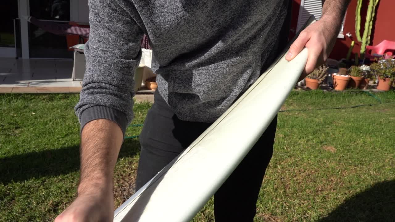 surfista en casa preparando la tabla