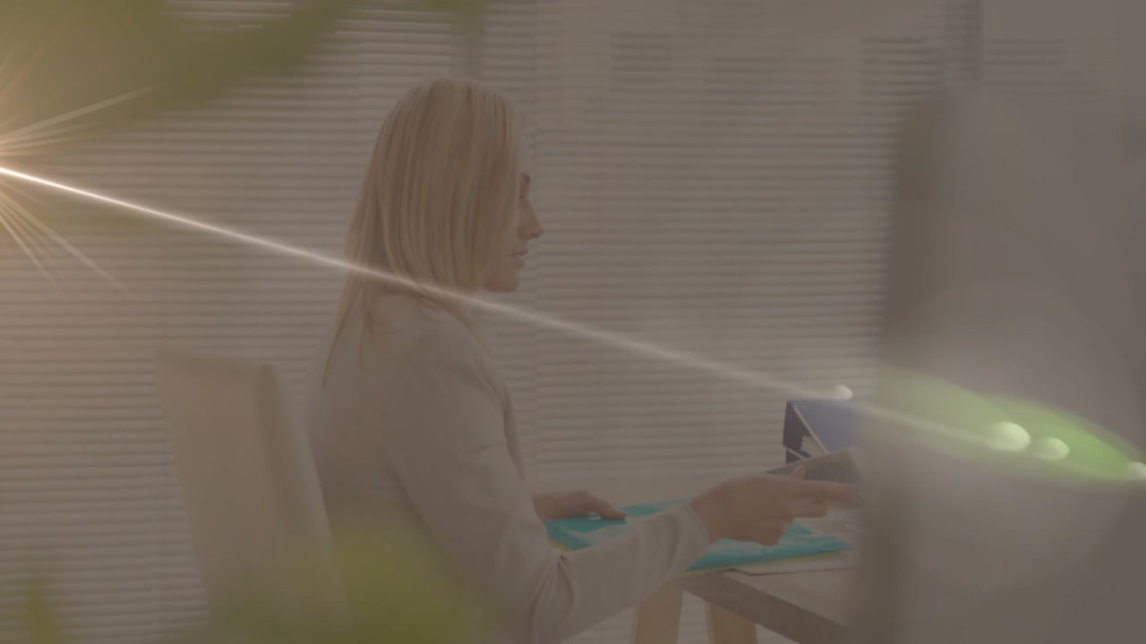 businesswoman consulting teal folder at desk, featuring animated data chart and lens flare