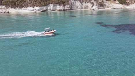 chasing the boat ont the water with turquoise clear water in zakynthos greece