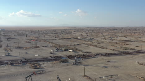 wells with pump jacks on oil field, central california usa