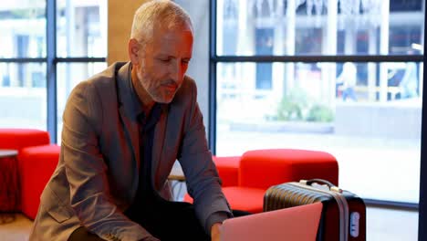 Businessman-using-laptop-in-hotel-lobby-4k