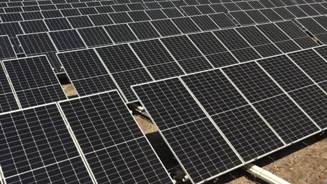aerial view of solar panels farm photovoltic (pv) solar panels harness sunlight to generate electricity.4k video