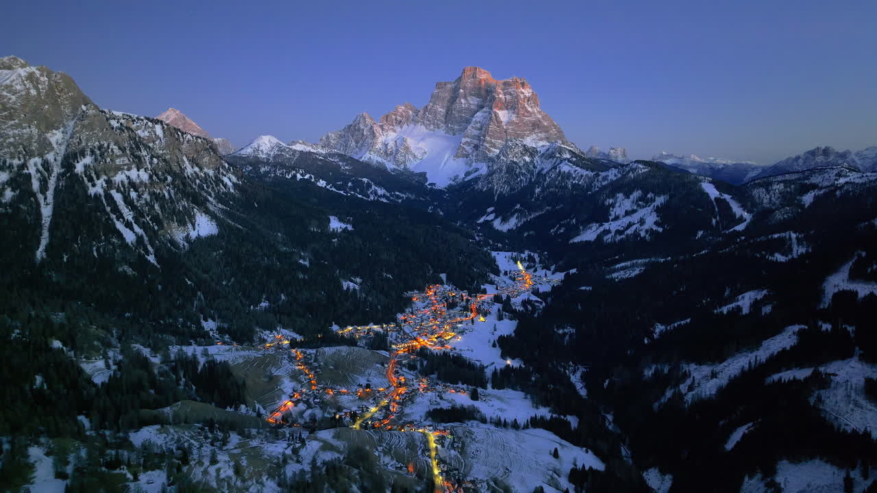 Aerial drone view of the Selva di Cadore comune illuminated at night in the province of Belluno, Dolomites, Italy