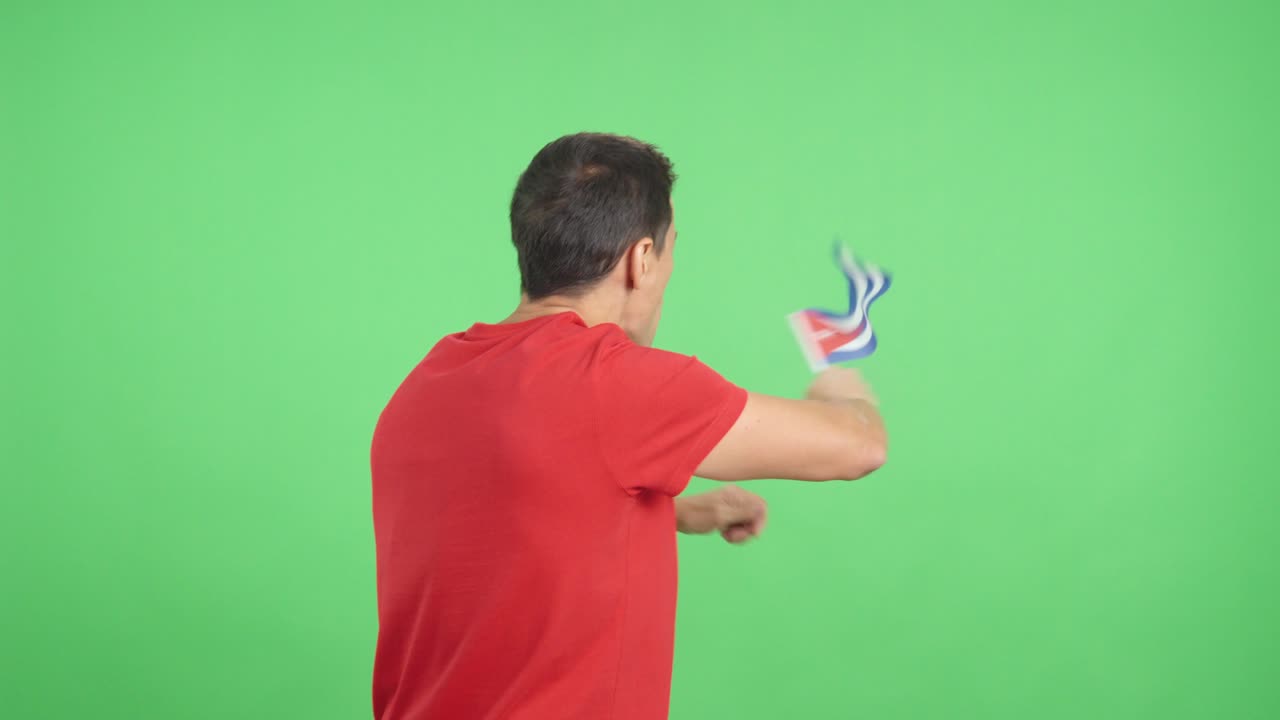 Rear view of a man waving a cuban pennant